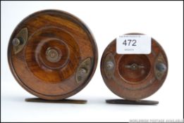 Two vintage wooden and brass decorated fishing reels,