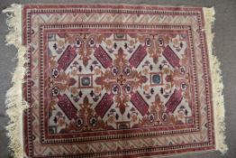 A Turkish 20th century Mikra rug having red ground with central medallions with geometric borders