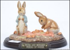 A Beswick Beatrix Potter figurine group Peter and Benjamin picking up onions 2804/3000 on plinth