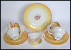 A vintage Foley china part tea service, each decorated with yellow lines and florals.