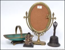 A collection of vintage brasswares to include a brass deity figurine of Ganesh, a cast iron bell,