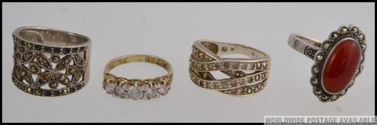 A collection of 4 silver ladies dress rings to include marcasite fret pierced, stone set,