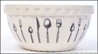A large Pountney of Bristol ceramic mixing bowl with cutlery design to the outer.