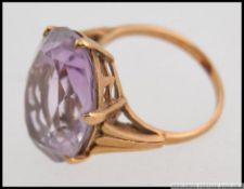 A vintage large ladies 9ct gold and amethyst set dress ring.