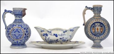 A large German blue salt glazed stoneware relief moulded ewer along with a similar designed moon