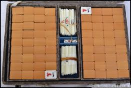 A mid century cased Mah Jong domino game set having bone and bamboo style tiles along with a