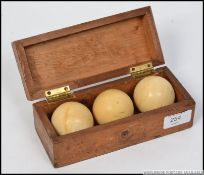 A cased set 3 Victorian snooker balls within a Burroughes & Watts ' Etoliated Annealed ' Solid