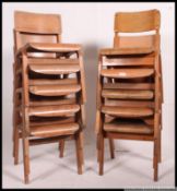 A stack of 10 mid century bentwood panel seat and panel back plywood school / hall chairs.