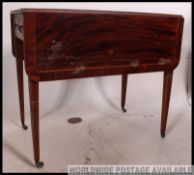 A Georgian flame mahogany inlaid Pembroke table.