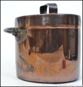 A large late 19th early 20th century copper lidded cooking pot, flat base with swing handle,