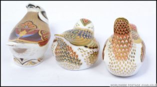 Three Crown Derby paperweights Crested Tit with heptagonal gold button and two other birds one with