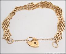 A 9ct gold bracelet having heart shaped locket clasp, stamped to the clasp and bracelet,