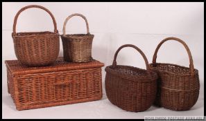 A collection of vintage whicker baskets and hampers, varying sizes and styles.