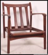 An excellent Danish 1950's open frame teak wood easy armchair raised on angular supports with