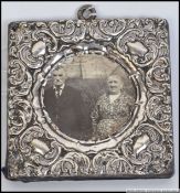 A silver hallmarked rococo miniature picture frame.