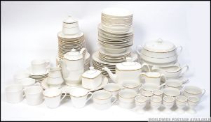 A large collection of white and gold dinner service pieces - comprising of Royal Doulton Gold