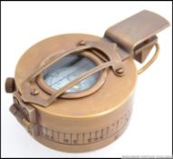 A brass military style compass.