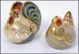 A pair of Royal Crown Derby paperweights Farmyard Hen 330/5000 and Farmyard Cockerel 290/5000 both