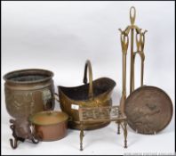 A collection of brass wares to include a coal scuttle, fire side compendium set,