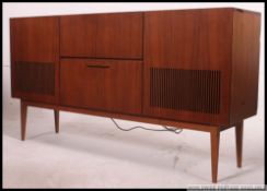 A 1970's retro teak wood stereogram with inset record deck, vented speaker front,