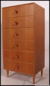A retro 1970's Ernest Gomme for G-Plan light oak pedestal chest of drawers raised on tapered legs.