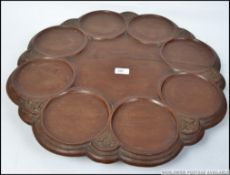 A large carved hard wood revolving sectional Lazy Susan food serving dish.