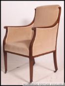 An Edwardian mahogany inlaid salon chesterfield armchair.