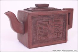 A Chinese terracotta Yi-Xing teapot.
