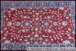A good Turkish rug with red floral central ground and medallions having geometric borders and
