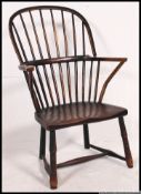 A 19th century beech and elm country Windsor armchair with panel seat on turned legs having lather