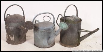 A collection of vintage galvanised metal watering cans and trays and baths etc ( see illustrations