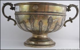 A silver hallmarked large twin handled rose bowl embellished with art nouveau reeding and scrolled