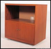 A 1970's retro teak side cabinet of Danish influence. The open recess over twin door cabinet.