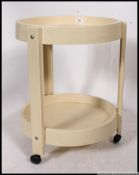 A 1970's Italian vintage two tier round plastic side table / trolley on original castors