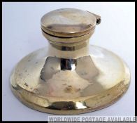 A hallmarked silver inkwell of circular form, with hinged lid.