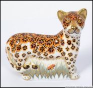 A Royal Crown Derby paperweight Leopard Cub with gold stopper.