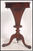 A 19th century Victorian flame mahogany trumpet shaped workbox.
