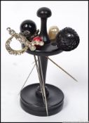 A collection of Victorian and 20th century hatpins of decorative form set to an ebonised pin