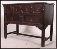 A Jacobean Revival oak dresser base,early 20th century, fitted with panelled frieze drawers,