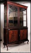 A large Edwardian flame mahogany library bookcase cabinet.