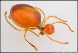 A believed Russian high carat ( tests between 18-22ct )amber set bug brooch of large form.