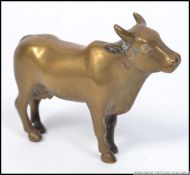 A good 19th century Indian brass figurine of a cow having central seam with the back leg stamped `B.