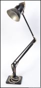 A pre-war black Industrial Herbert Terry anglepoise lamp raised on square terraced base with