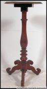 A Victorian oak tripod pedestal wine table.