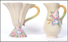 A Clarice Cliff reeded conical vase on foliate moulded base marked 830 along with a Clarice Cliff