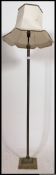 Brass Corinthian column standard lamp raised on stepped square base.