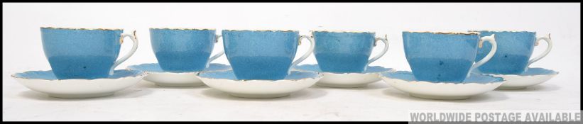 Coalport 6 blue cups and saucers with gilt rim and floral design to interior signed P Gramet