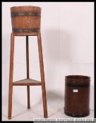 A 1930's coopered oak barrel planter raised on squared legs with another mahogany circular wooden