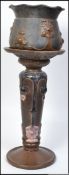 An early 20th century large Art Nouveau ceramic pedestal plant stand by Bretby.