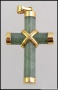 A 14ct / 535 gold and jade crucifix necklace pendant.